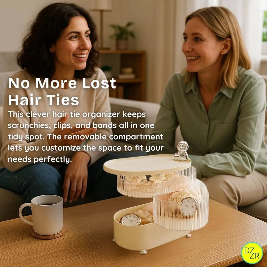 Two women sitting on a couch with a hair tie organizer in front of them, featuring text about the product.