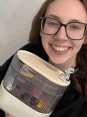 Person holding a pen holder with a barcode on a plain background