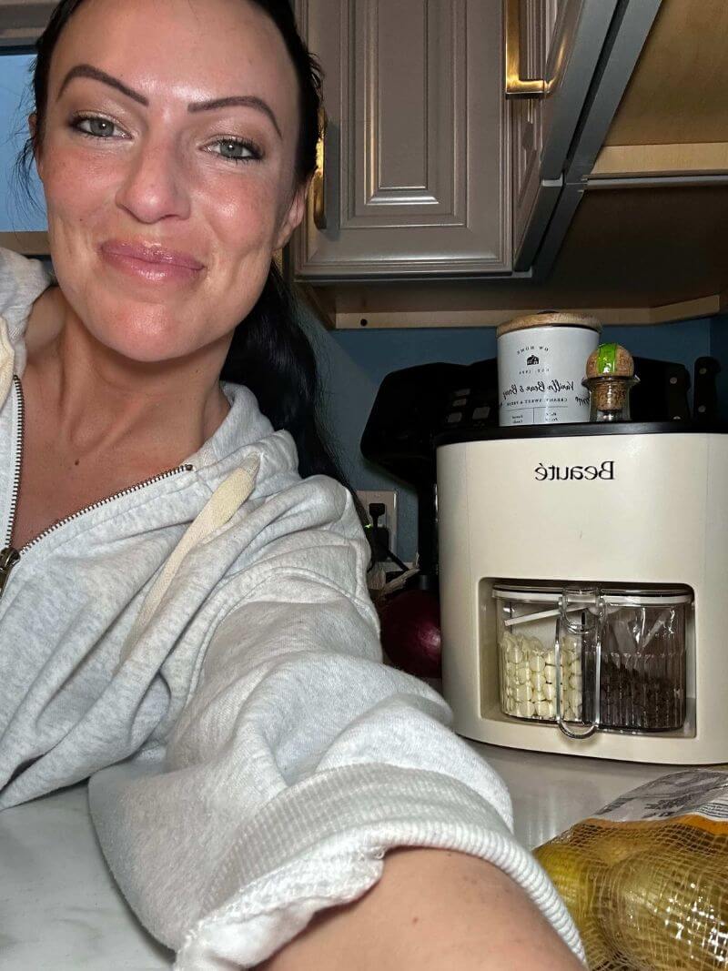 Woman in a kitchen with a rotating kitchen organizer in the background