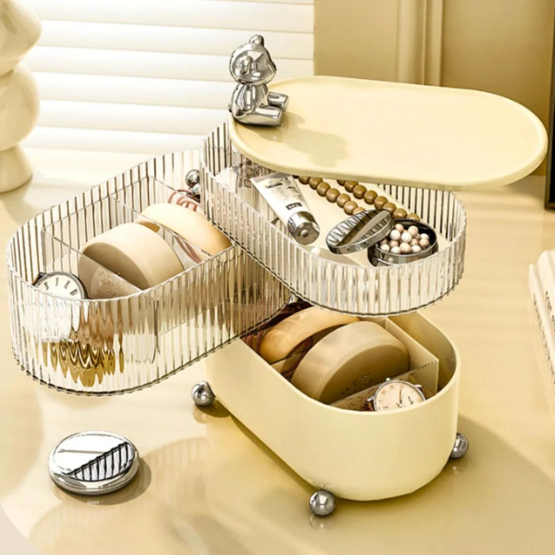 3-tier jewelry organizer with watches and jewelry on a beige surface.